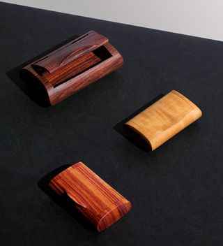pillbox is hand-carved from a single piece of wood and has a curved lid