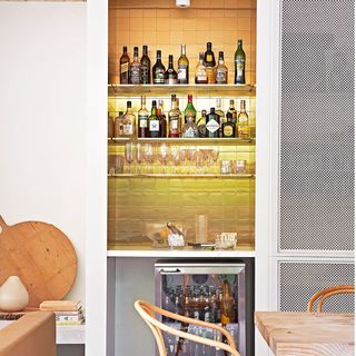 metalic bar with brass tiles and mini fridge