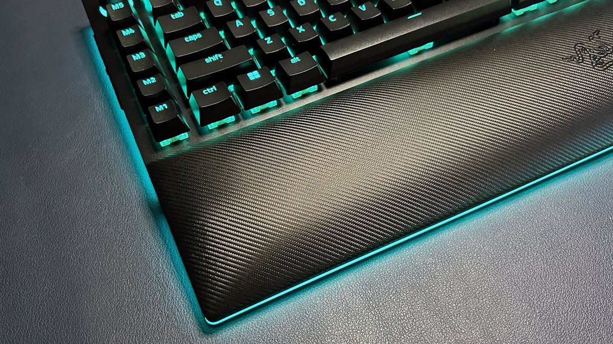 BlackWidow V4 Pro gaming keyboard with wrist rest and blue lighting around base
