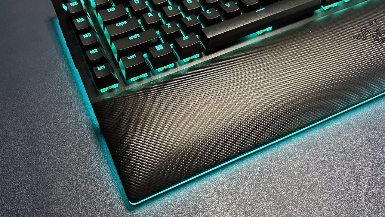 BlackWidow V4 Pro gaming keyboard with wrist rest and blue lighting around base