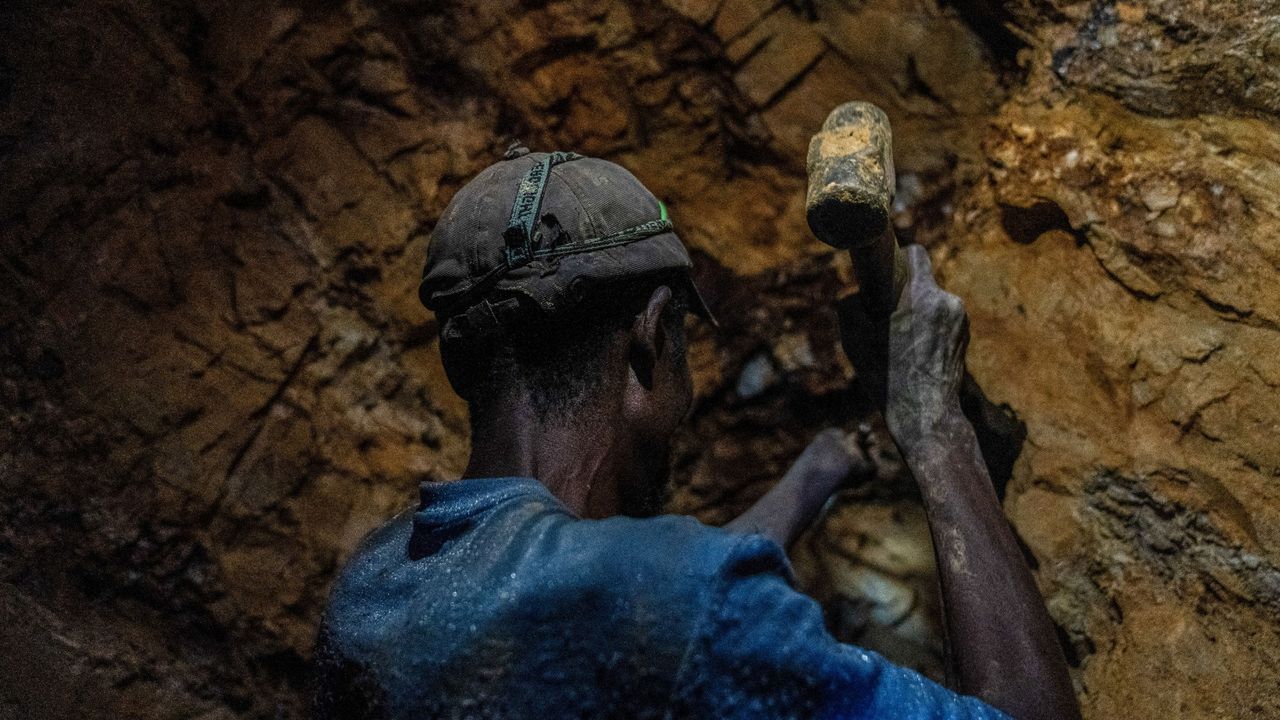 A miner works a seam in a gold mine in the east of the Democratic Republic of Congo