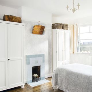 bedroom storage with wardrobe and fireplace