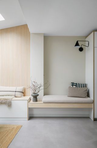 Light wood panelling and bench against warm neutral wall