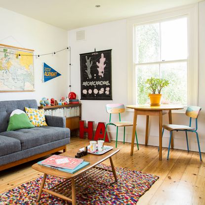 living room white walls wooden flooring with sofa set