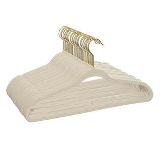 A set of beige velvet hangers with gold hardware