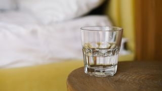 Glass of water on bedside table