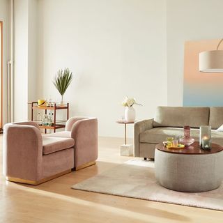 Tete-a-tete sofa in a social living room with bar car, gray sofa, round ottoman coffee table