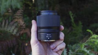 Nikon Z 50mm f/1.4 lens in the hand