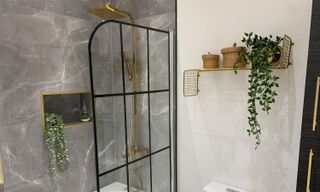 White modern bathroom with black accent and gilded features