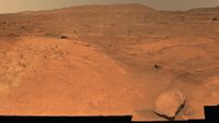 A view of a region of Mars with some rocks strewn about.