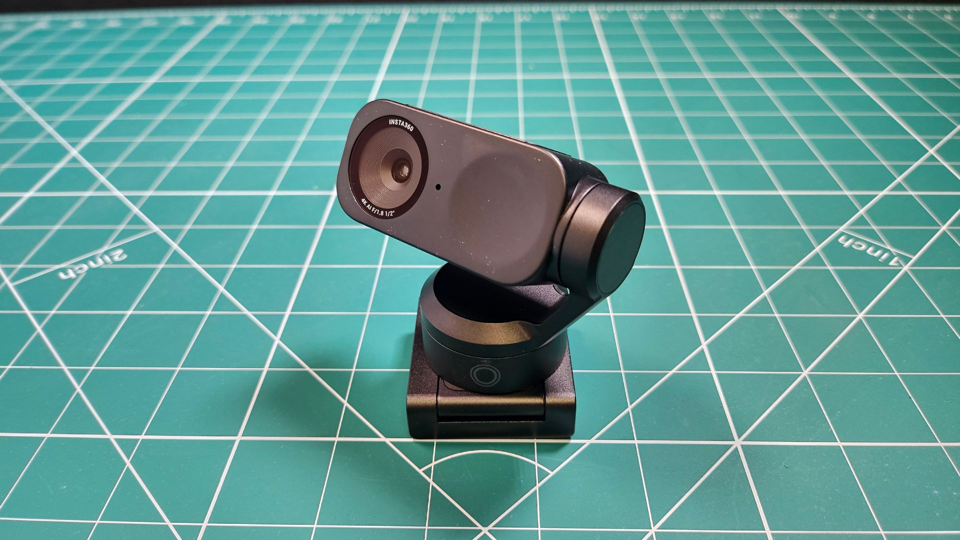 The Insta360 Link 2 looking up from a desk