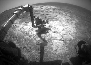 NASA's Opportunity Mars rover examines a rock dubbed "Athens" in this image taken on March 25, 2015, by the rover's front hazard avoidance camera.