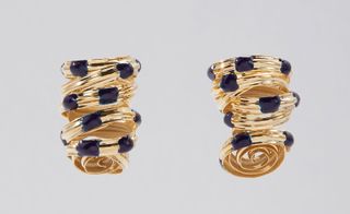 Gold-coated brass curly earrings with blue dots on