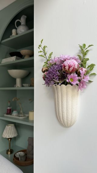 A wall featuring a flower vase