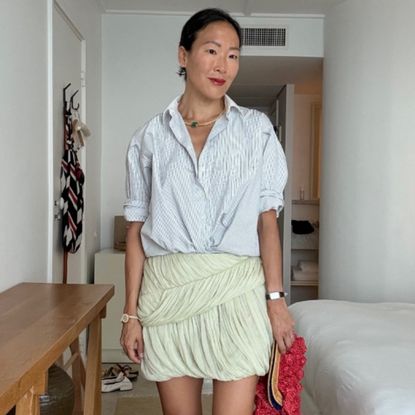 Irene Kim wearing a blouse and a skirt