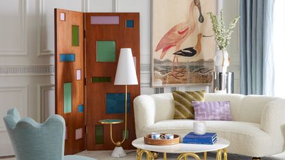 Jonathan Adler-designed living room, featuring curved and scalloped furniture and a floor lamp that doubles as a side table