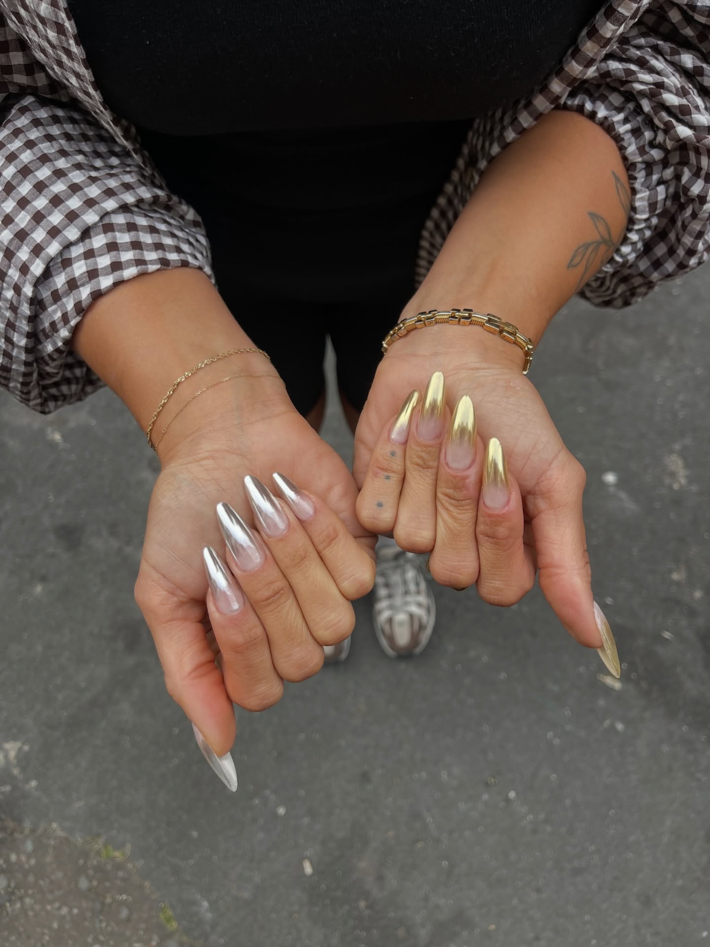 Long almond nails with silver chrome on one hand and gold chrome on the other