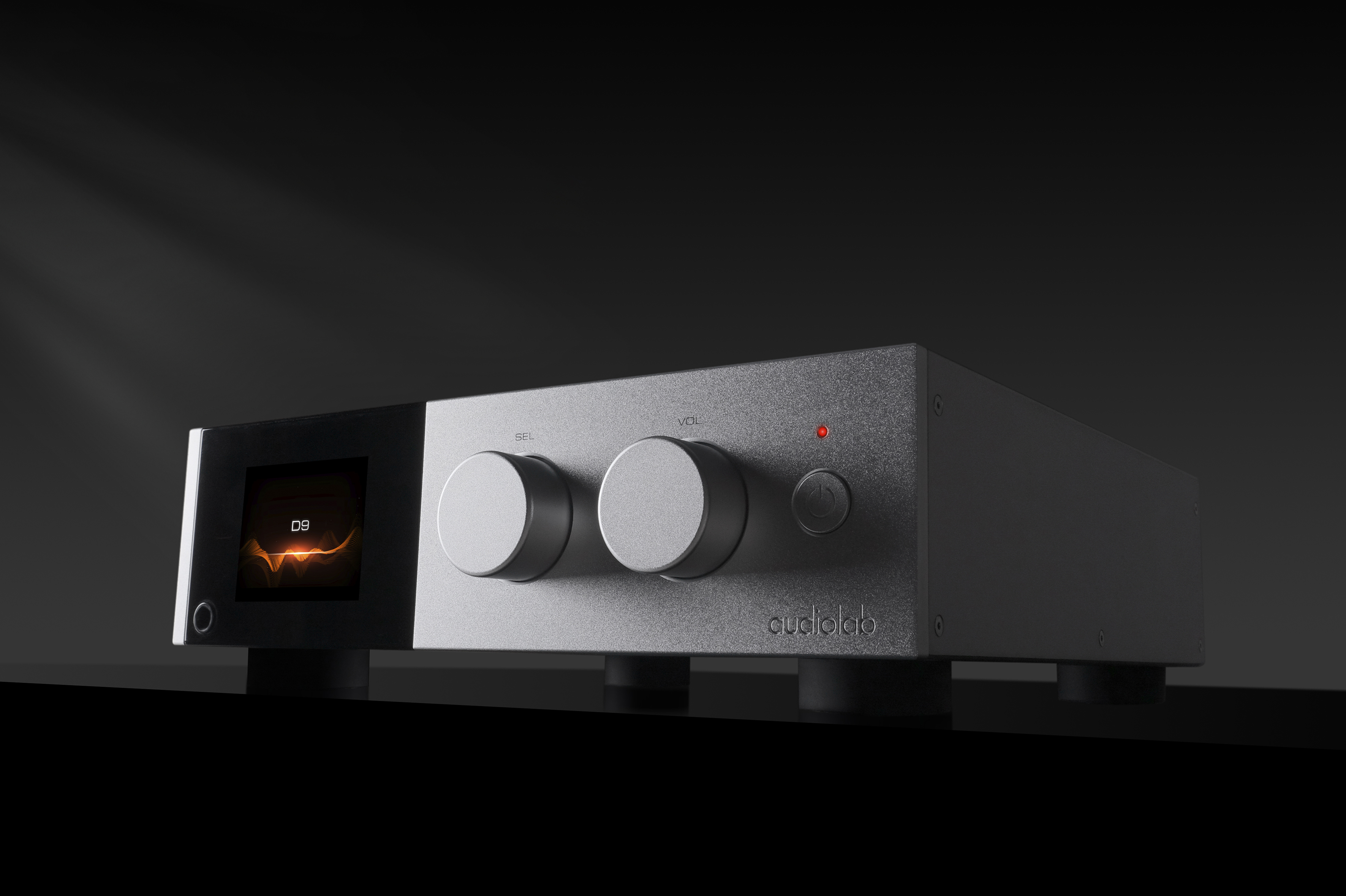A silver Audiolab D9 DAC moodily shot with shadows falling from its twin front dials.