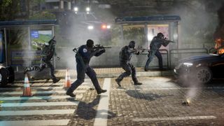 Alpha Response police officers walking in a line with guns aimed