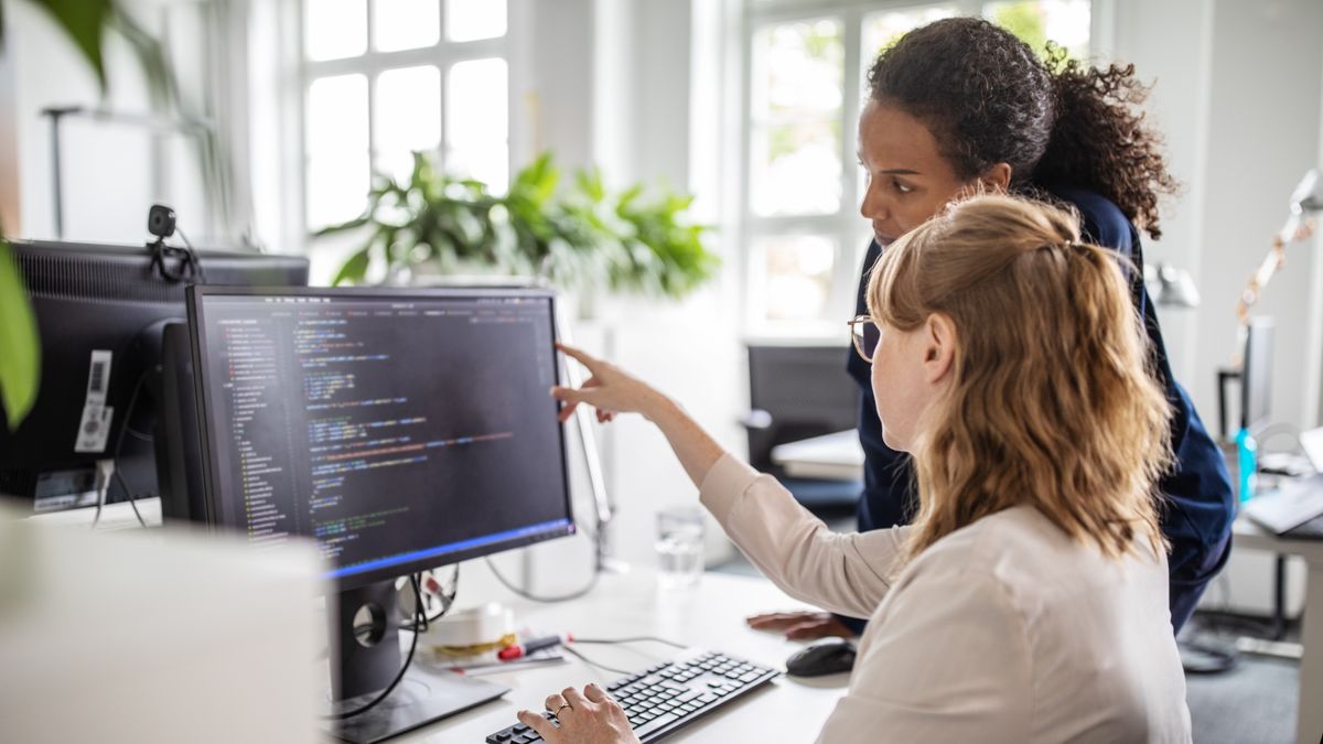 Agile development concept art showing team members discussing project progress on a computer screen with software code.