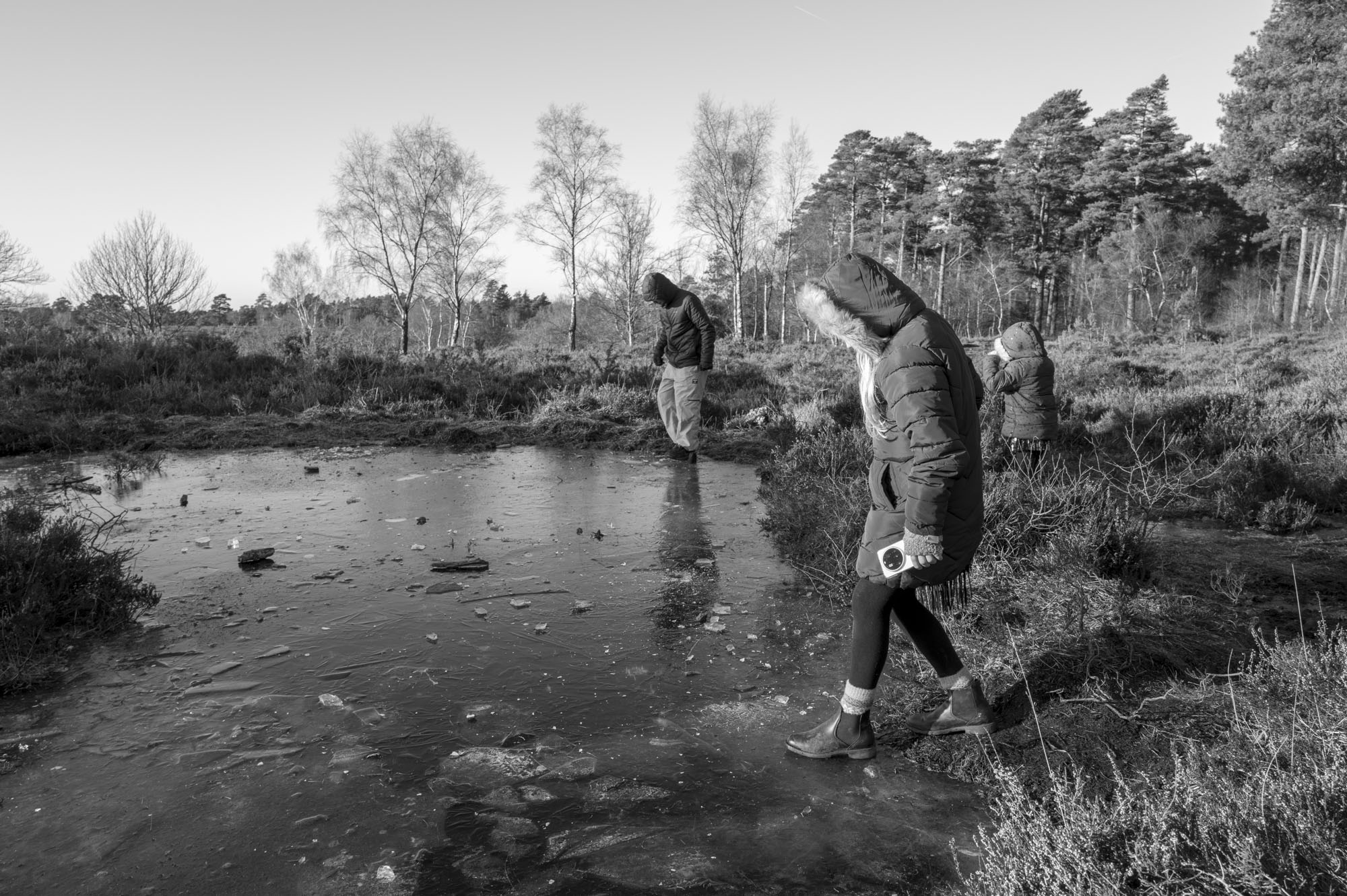 Leica Q3 Monochrom sample gallery: children stepping onto a frozen pond