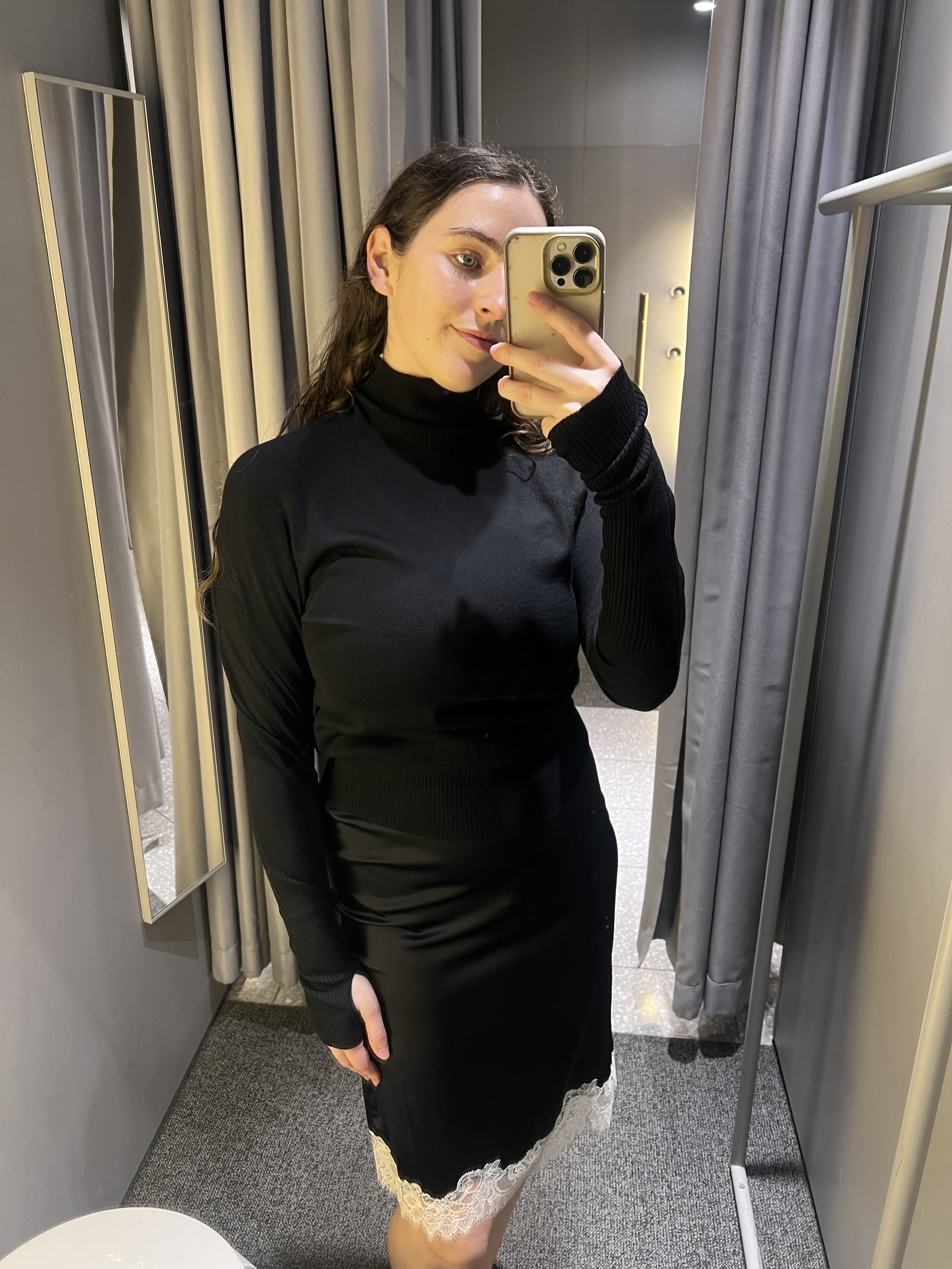 An image of SEO Writer Ava Gilchrist wearing a lace-trim satin skirt from Arket.