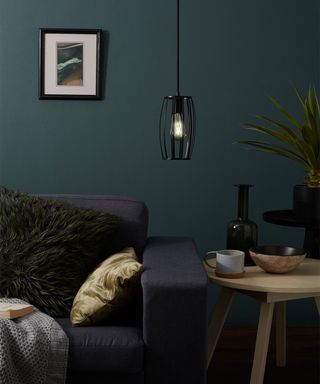 Smart bulb in a living room setting with green wall