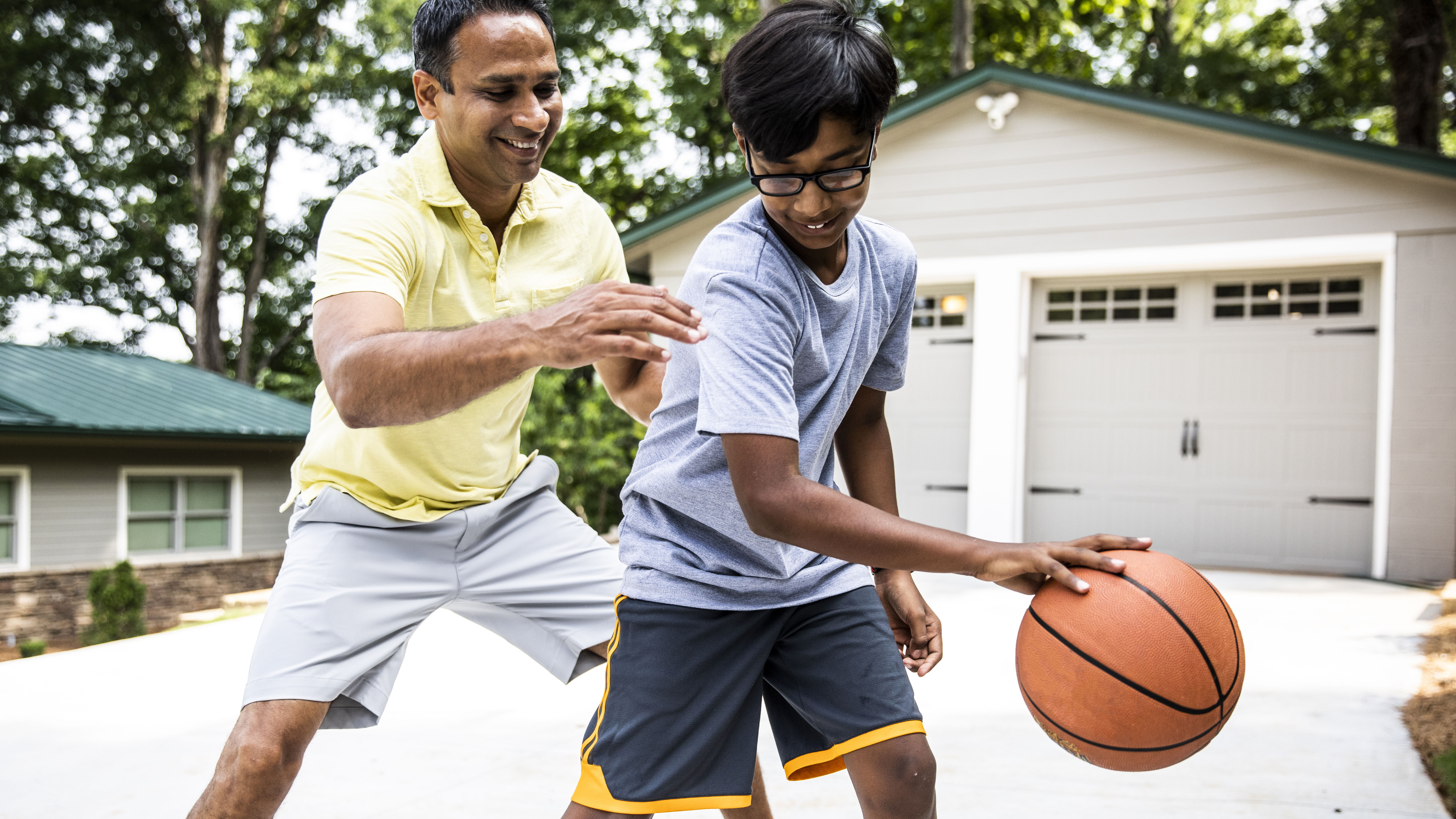 father and son playing basketball