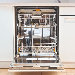 an open empty dishwasher in a klitchen