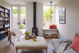 white snug room with small stove and picture window