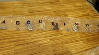 Bags of screws for the Revive Gaming Desk
