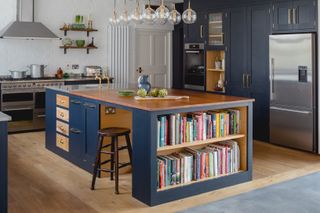 Blue kitchen with island and book storage