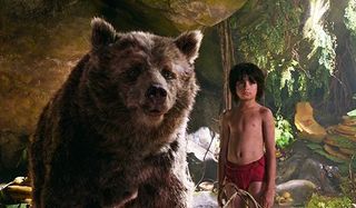 Disney's The Jungle Book Baloo and Mowgli stand underneath some rocks