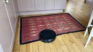 iRobot Roomba Combo 10 Max cleaning around a rug in reviewer's home