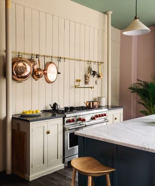 Pot filler taps trend, brassy colored tap by deVOL in a painted kitchen
