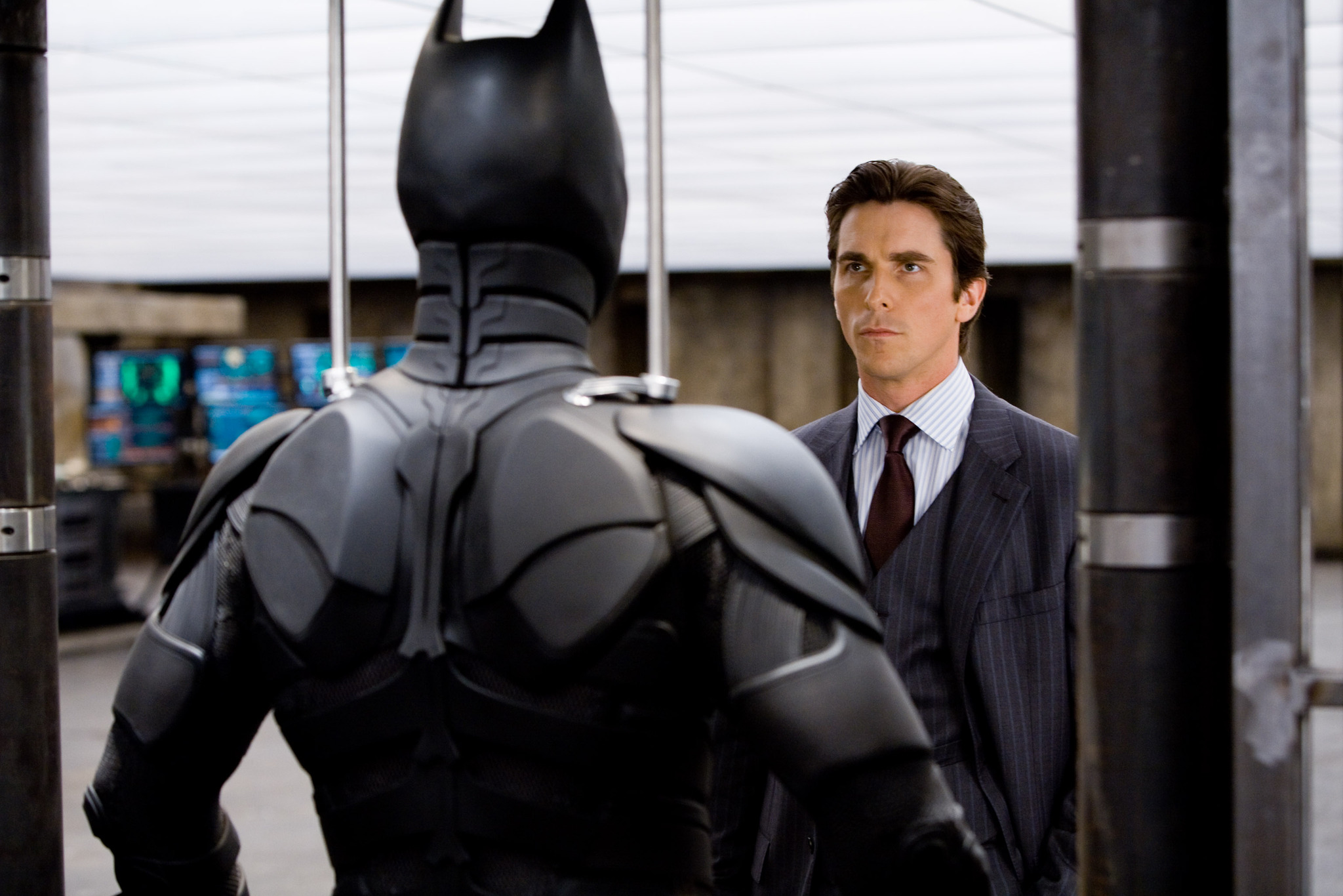 Bruce Wayne looking at the bat suit in The Dark Knight