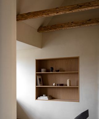 a deep wooden shelf in an attic