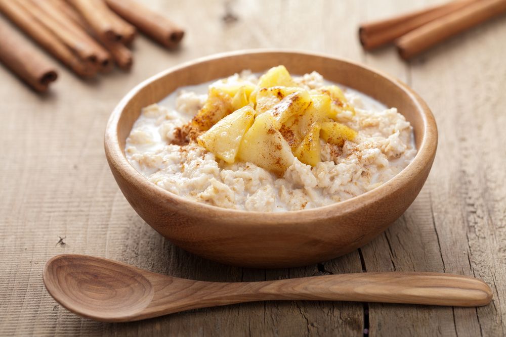 A bowl of oatmeal with apples