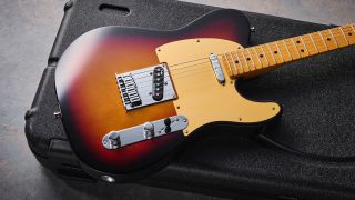 A Fender American Ultra II Telecaster lying on top of a hard case