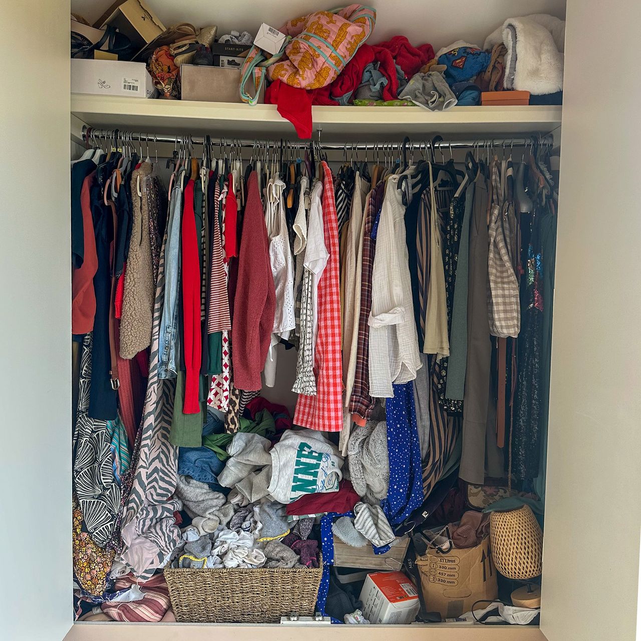 Open wardrobe filled with clothes and accessories