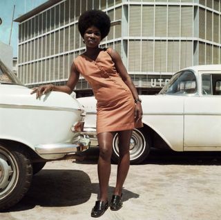 Sick Hagemeyer shop assistant posing in front of the United Trading Company headquarters, Accra,1971