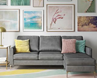 A budget grey 4-seater sofa by Wayfair with gallery wall and striped rug