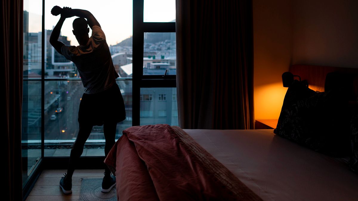 Man stretching in hotel room