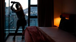 Man stretching in hotel room