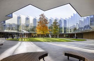 courtyard at AstraZeneca's Discovery Centre by Herzog de Meuron featuring a green space in the center with trees