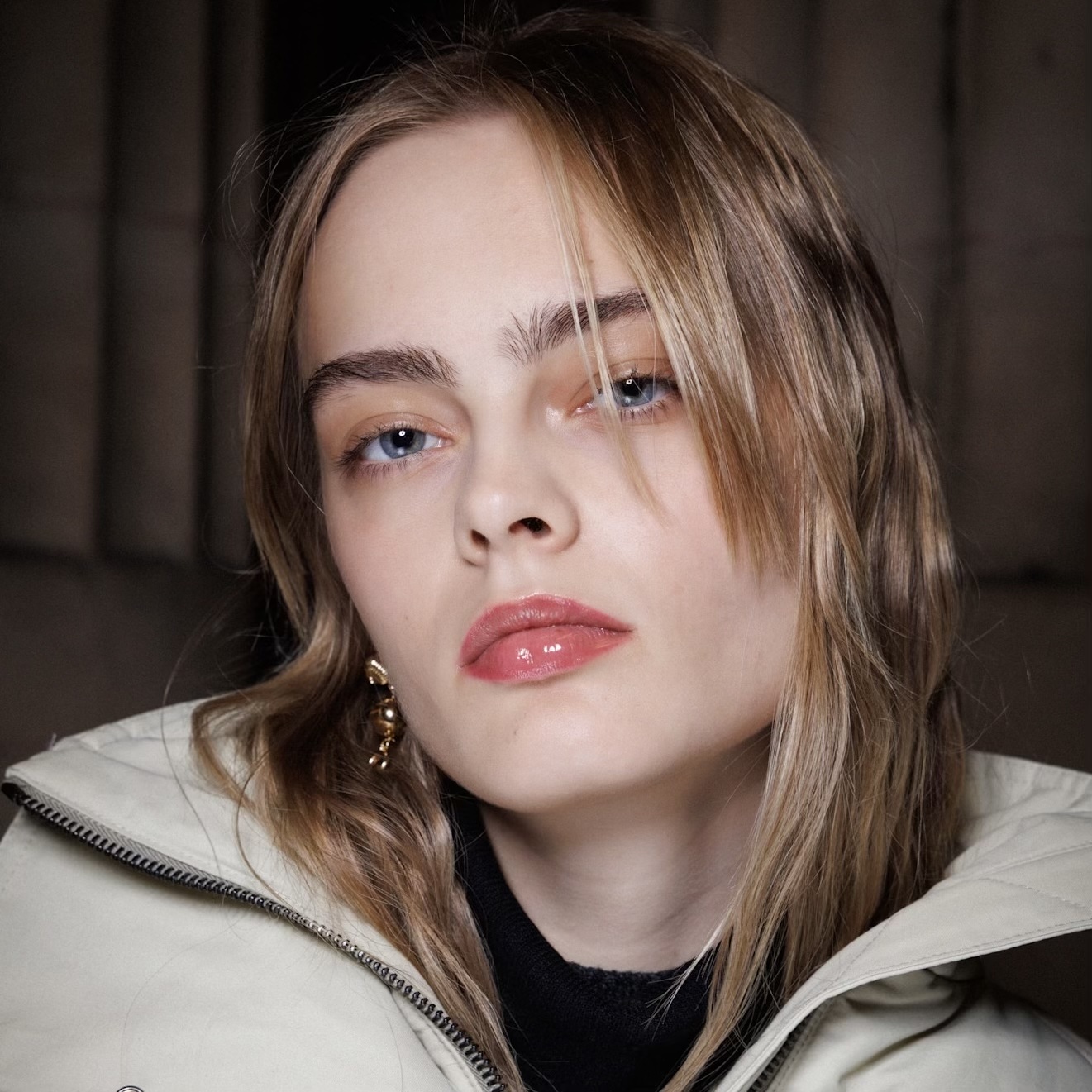 lip oil on a model with a white jacket