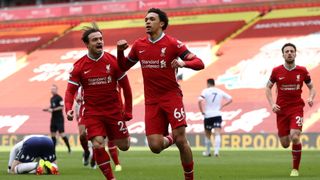 Trent Alexander-Arnold of Liverpool celebrates with teammate Xherdan Shaqiri after scoring their team's second goal during the Premier League match between Liverpool and Aston Villa at Anfield on April 10, 2021