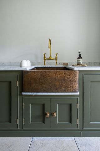 copper sink in kitchen painted in green paint