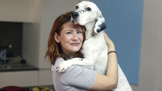 Big dog cuddling woman