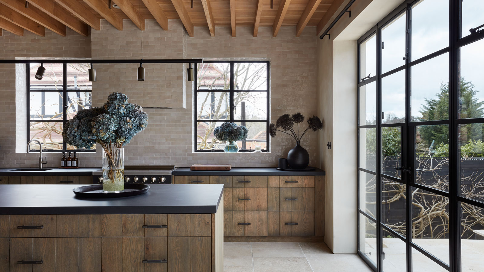 modern wooden kitchen with black metal framed windows and doors